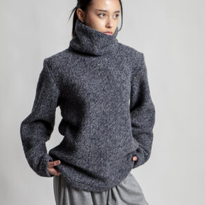Chunky textured turtleneck sweater with generous silhouette and artisan finish.